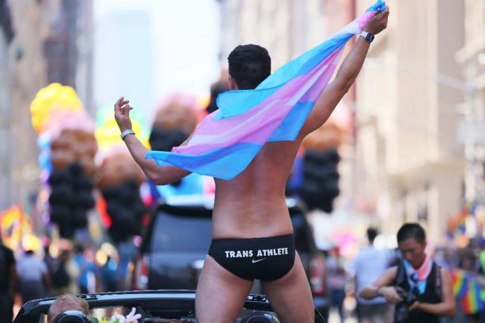 Schuyler Bailar, the first transgender athlete to compete in any sport on an NCAA Division I men's team and NYC Pride grand marshal, waves as he participates in the New York City Pride Parade on Fifth Avenue on June 26, 2022 in New York City (Photo b