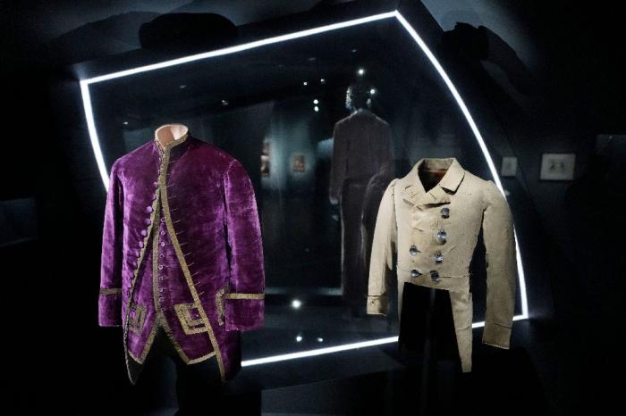 A livery coat and waistcoat worn by and enslaved servant, left, and a Brooks Brothers coat worn by an enslaved child are displayed at the Metropolitan Museum of Art's Costume Institute exhibition, "Superfine: Tailoring Black Style," on Satu