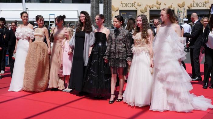 Luise Heyer, from left, Lea Drinda, producer Maren Schmitt, Hanna Heckt, director Mascha Schilinski, Susanne Wust, Lena Urzendowsky, Laeni Geiseler and Luzia Oppermann pose for photographers upon arrival at the premiere of the film 'Sound of Falling&