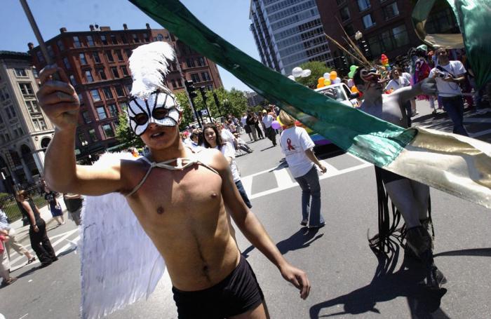 Parade goers dressed in costume march down the street on June 12, 2004 during the 34th annual Boston Gay Pride Parade in Boston, Massachusetts. This year marks the first time the parade has taken place since the state legalized same sex marriage, and offi