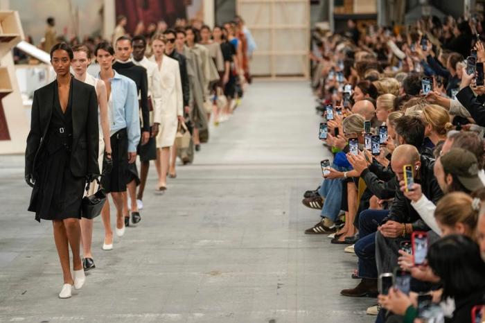 Models wear creations as part of the Tod's women's Spring Summer 2024 collection presented in Milan, Italy, Friday, Sept. 22, 2023. (AP Photo/Luca Bruno)