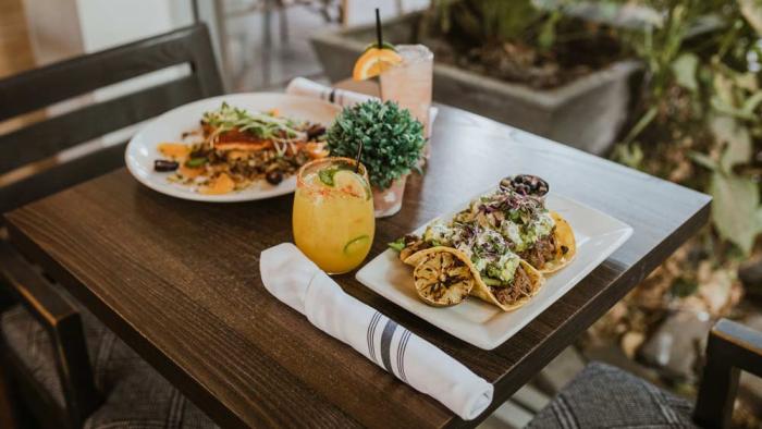 Enjoy fresh, seasonal cuisine at The Herb Box in Old Town Scottsdale (shown: Grapefruit & Sugar Charred Salmon, Paloma cocktail, Market Street Short Rib Tacos, Spicy Mango Marg)