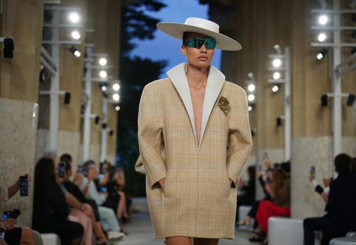 A model wears a creation by Louis Vuitton during a fashion show for the Cruise 2025 collection in the Park Guell in Barcelona, Spain, Thursday, May 23, 2024