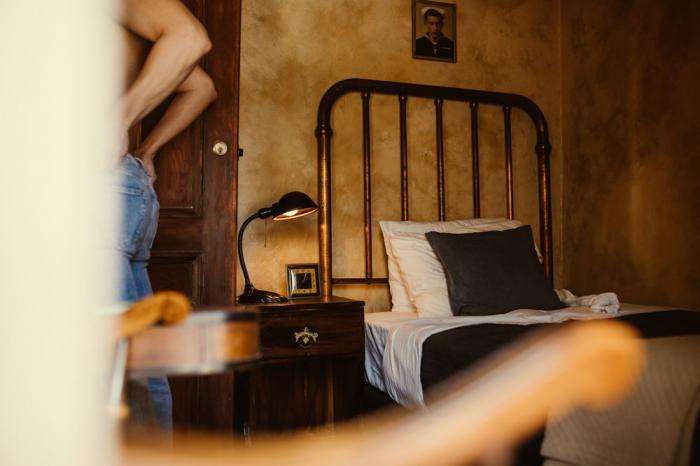 Model Mickey DiPietro in a room at Crew's Quarters Boarding House.