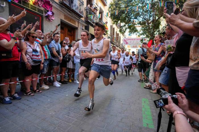 Participants compete during the Pride Week annual high heels race in the Chueca district, a popular area for the gay community in Madrid, Spain, Thursday, July 4, 2024