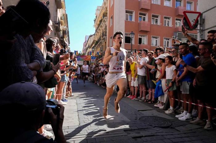 Participants compete during the Pride Week annual high heels race in the Chueca district, a popular area for the gay community in Madrid, Spain, Thursday, July 4, 2024