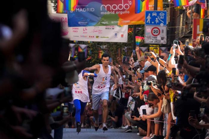 Participants compete during the Pride Week annual high heels race in the Chueca district, a popular area for the gay community in Madrid, Spain, Thursday, July 4, 2024