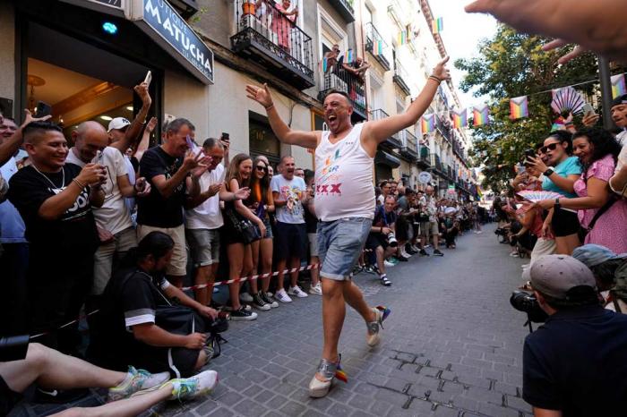 A participant reacts while coming in last during the Pride Week annual high heels race in the Chueca district, a popular area for the gay community in Madrid, Spain, Thursday, July 4, 2024