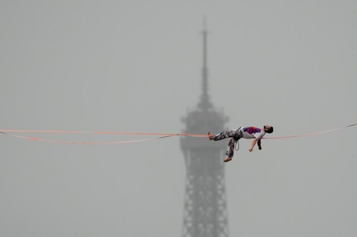 A tight rope walker performs in Paris, France, during the opening ceremony of the 2024 Summer Olympics, Friday, July 26, 2024. (AP Photo/Aaron Favila)