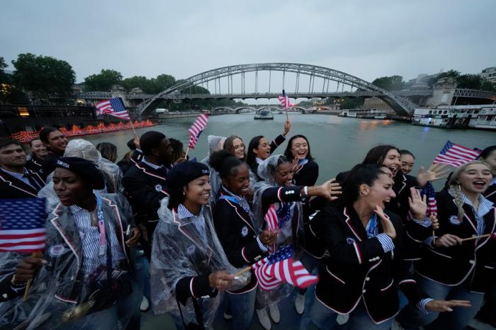 Members of the United States Team travel along the Seine River in Paris, France, during the opening ceremony of the 2024 Summer Olympics, Friday, July 26, 2024. (AP Photo/Ashley Landis, Pool)