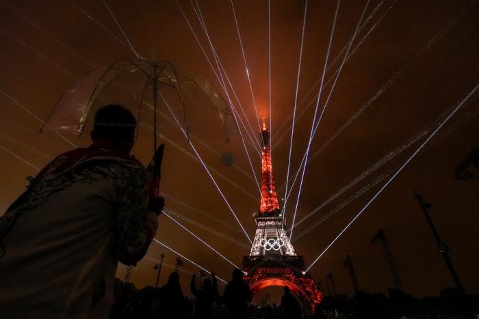 A light show is displayed on the Eiffel Tower during the opening ceremony of the 2024 Summer Olympics, Friday, July 26, 2024, in Paris, France. (AP Photo/Andy Wong)