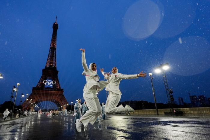 Egyptian athletes leap while participating in the opening ceremony of the 2024 Summer Olympics, Friday, July 26, 2024, in Paris, France. (AP Photo/Andy Wong)