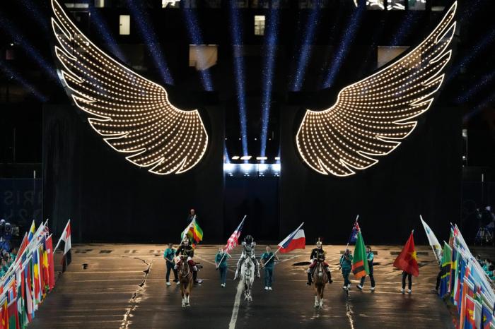 Entertainer's perform in Paris, France, during the opening ceremony of the 2024 Summer Olympics, Friday, July 26, 2024. (AP Photo/David J. Phillip)