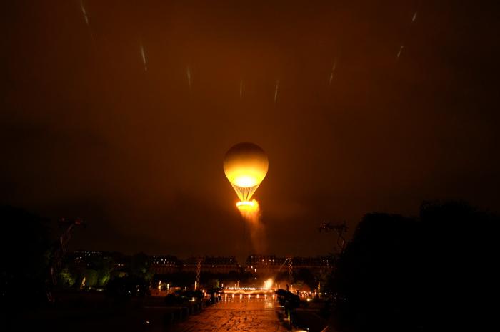 The Olympic Flame rises on a balloon after being lit in Paris, France, during the opening ceremony of the 2024 Summer Olympics, Friday, July 26, 2024. (AP Photo/Rebecca Blackwell)