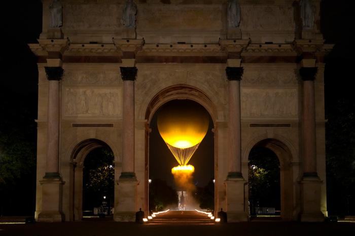 The cauldron rises by the Arc de Triomphe du Carrousel in Paris, France, during the opening ceremony of the 2024 Summer Olympics, Friday, July 26, 2024. (AP Photo/Vadim Ghirda)