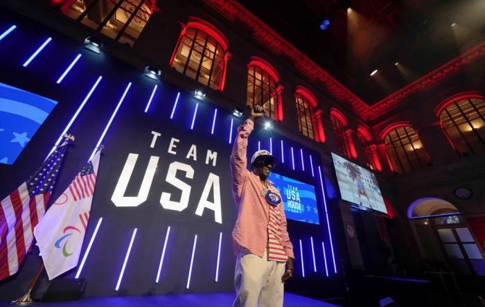 Flavor Flav gestures on the stage of the USA house at the 2024 Summer Olympics, Thursday, July 25, 2024, in Paris, France. (AP Photo/Luca Bruno)