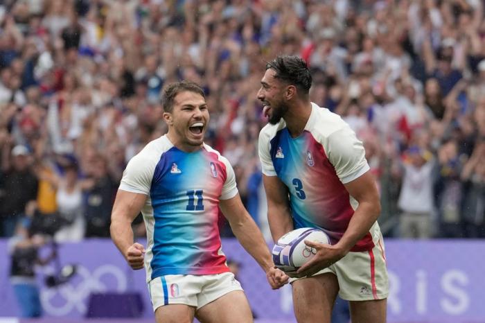 Rayan Rebbadj of France, right, celebrates after scoring a try with teammate Antoine Dupont of France during the men's semifinal Rugby Sevens match between South Africa and France at the 2024 Summer Olympics, in the Stade de France, in Saint-Denis, F