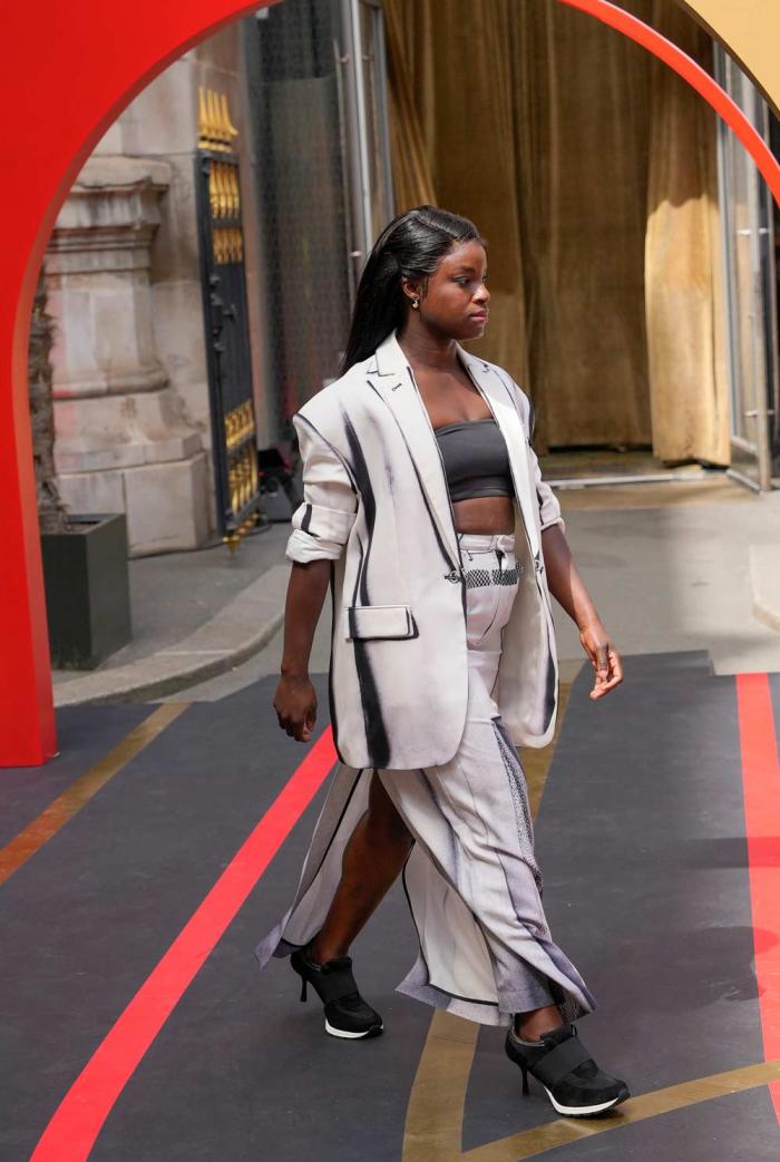 British former soccer player Eniola Aluko wears a creation by Keta Gutmane and Sneex footwear during the first gender equal Olympic Games fashion show, at the 2024 Summer Olympics in Paris, France, Sunday, July 28, 2024