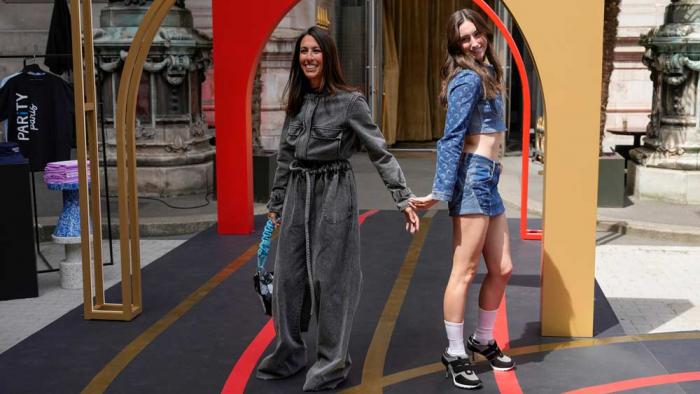 U.S. former swimmer Janet Evans, left, wears a creation by Veronique Leroy and her daughter Sydney Wilson wears a creation by Marine Serre and Sneex footwear, during the first gender equal Olympic Games fashion show, at the 2024 Summer Olympics in Paris,