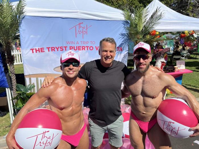 Two men from Tryst Puerto Vallarta surround Eric Baker