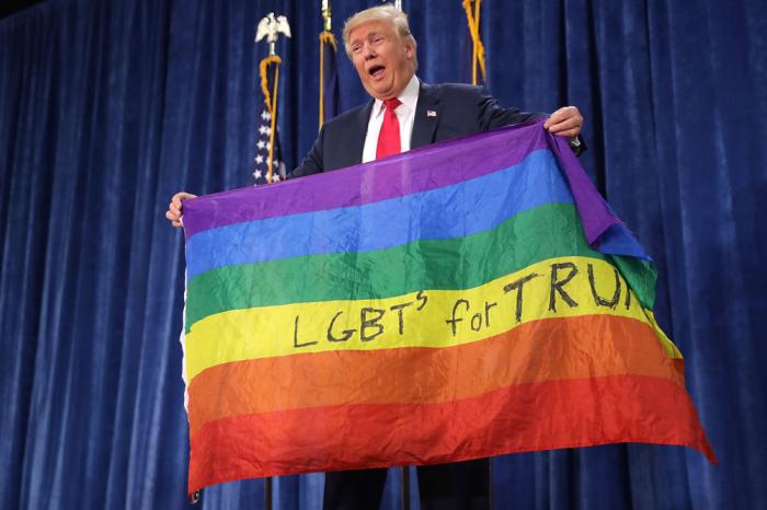 Republican presidential nominee Donald Trump holds an LGBT rainbow flag given to him by supporter Max Nowak during a campaign rally at the Bank of Colorado Arena on the campus of University of Northern Colorado October 30, 2016 in Greeley, Colorado. With