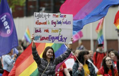 People take part in a march demanding same sex marriage in Northern Ireland, in Belfast city centre, Northern Ireland, Saturday May 18, 2019.