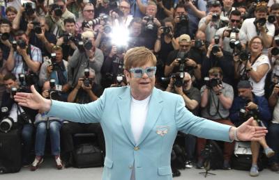 Elton poses for press at Cannes, 2019
