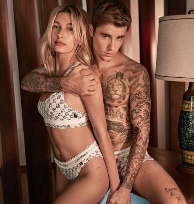 Hailey Baldwin, left, with husband Justin Bieber for Calvin Klein.