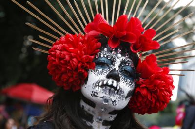 A woman dressed as Catrinas parade down Mexico City´s iconic Reforma Avenue.