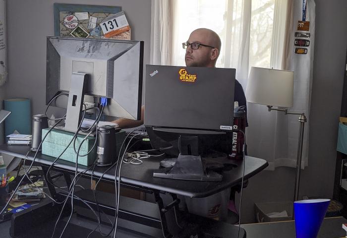 Eric Bellmore works from his home in Mount Pleasant, Mich., while following a coronavirus-related stay at home guideline.