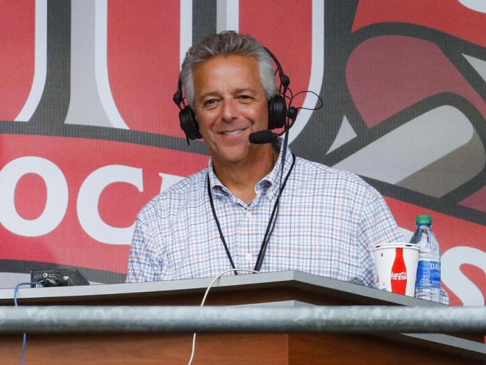 Cincinnati Reds broadcaster Thom Brennaman sits in a special outside booth before the Reds' baseball game against the Milwaukee Brewers in Cincinnati.