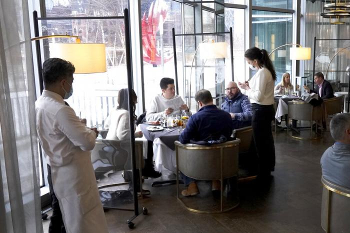 Patrons enjoy lunch indoors at Gibsons Italia restaurant in Chicago.