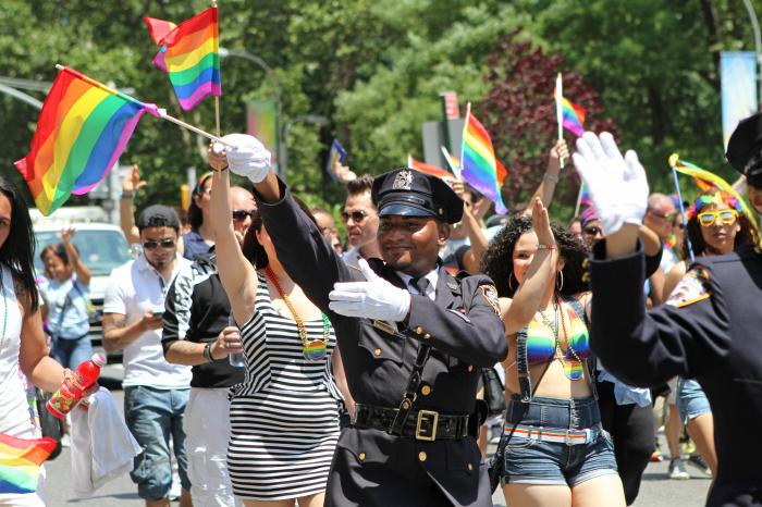 In this Sunday, June 29, 2014 file photo, NYPD police officers march along Fifth Avenue during the gay pride parade in New York.