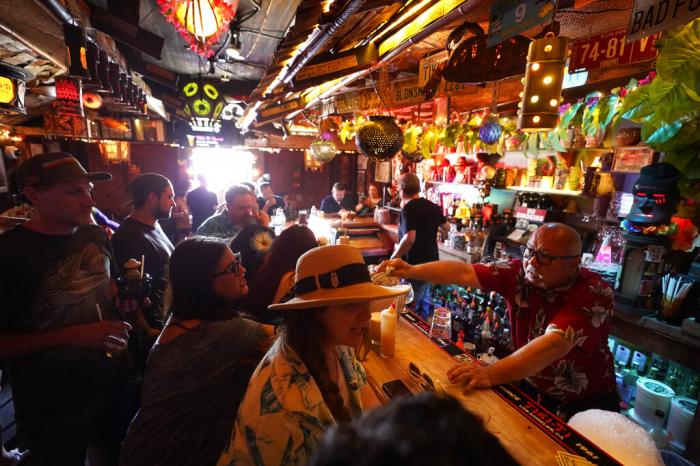 Patrons enjoy cold tropical cocktails in the tiny interior of the Tiki-Ti bar as it reopens on Sunset Boulevard in Los Angeles. 