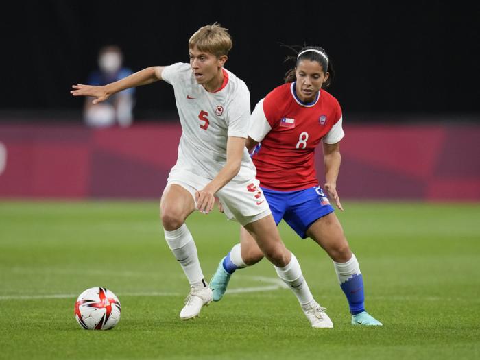Canada's Quinn, left, and Chile's Karen Araya battle for the ball during a women's soccer match at the 2020 Summer Olympics, Saturday, July 24, 2021, in Sapporo, Japan