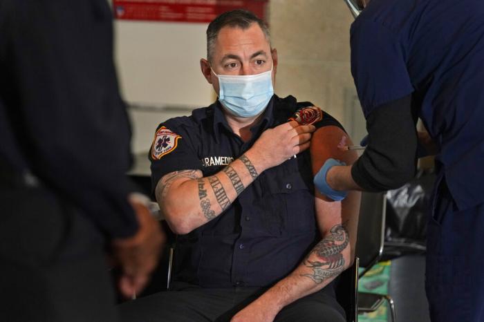 New York City firefighter emergency medical services personnel are vaccinated against COVID-19 at the FDNY Fire Academy in New York.