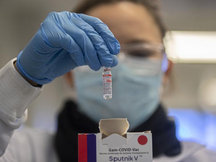 A Uniao Quimica pharmaceutical employee holds a vial at the company's control center for the Russian Sputnik V COVID-19 vaccine in Guarulhos in the greater Sao Paulo area of Brazil, May 20, 2021