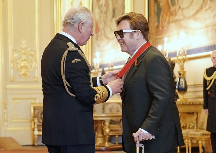 Sir Elton John is made a member of the Order of the Companions of Honour by Prince Charles during an investiture ceremony at Windsor Castle, in Windsor, England.