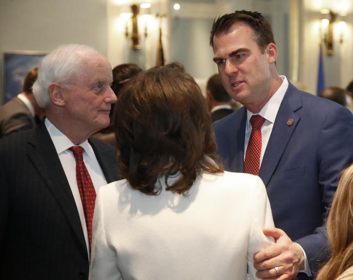 Kevin Sitt, right, talks with former Oklahoma Gov. Frank Keating, left, and Keating's wife Cathy, center, before his inauguration ceremonies in Oklahoma City.