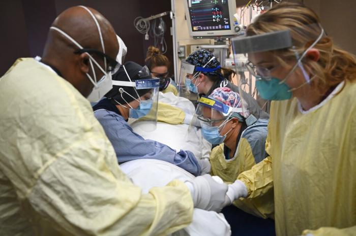 Critical care nurses and respiratory therapists flip a COVID-19 patient upright in North Memorial's South Six and South Seven Intensive Care Units. 