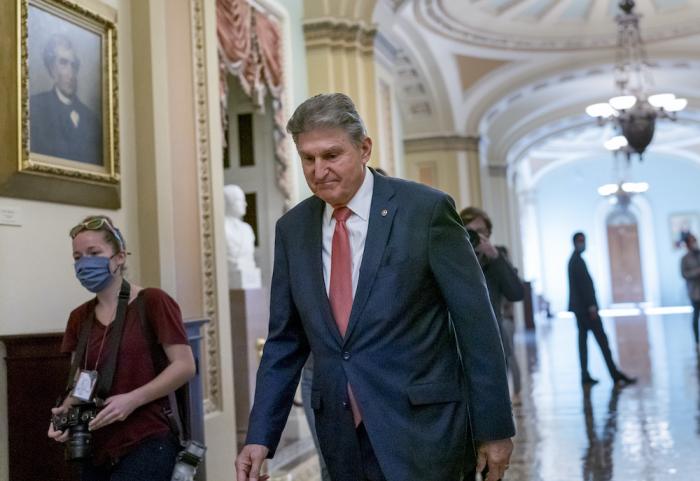 Sen. Joe Manchin, D-W.Va., walks to a caucus lunch at the Capitol in Washington.