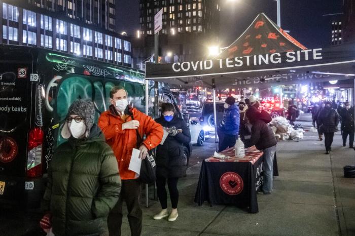 People wait on line to get tested for COVID-19 on the Lower East Side of Manhattan.