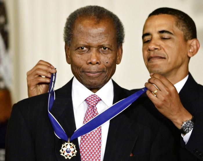 President Barack Obama presents the 2009 Presidential Medal of Freedom to Sidney Poitier during ceremonies in the East Room at the White House in Washington.