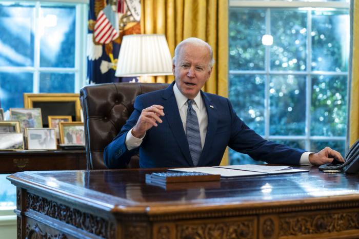 President Joe Biden speaks before signing an executive order to improve government services, in the Oval Office of the White House.