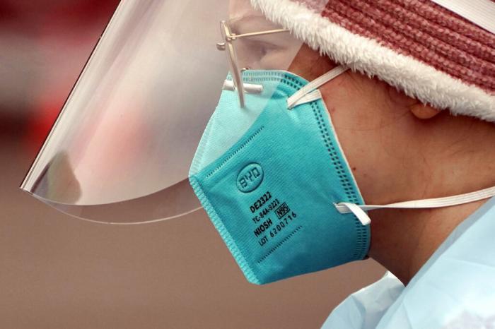 Linsey Jones, a medical assistant working at a drive-up COVID-19 testing clinic, wears an N95 mask, Jan. 4, 2022, in Puyallup, Wash.