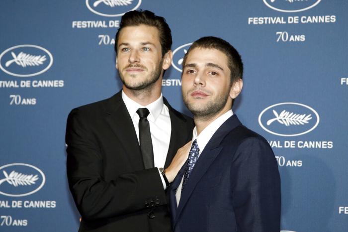 Out director Xavier Dolan, right, and actor Gaspard Ulliel pose for photographers during the photocall for the 70th anniversary of the Cannes Film Festival, in Paris.