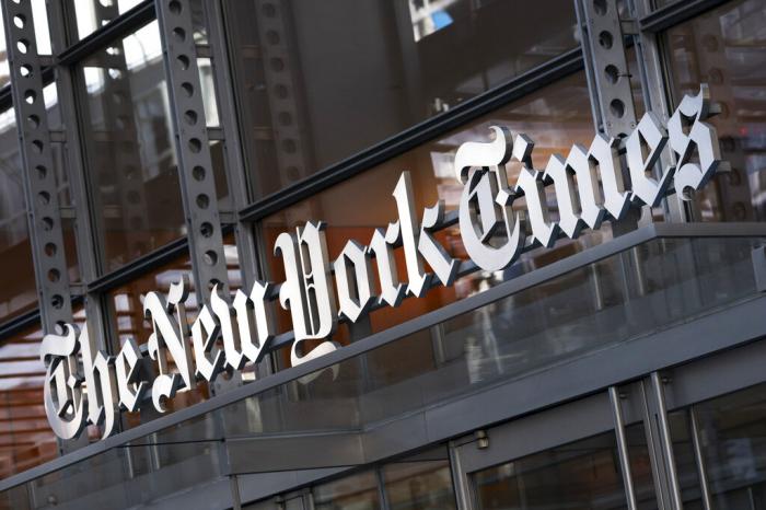 A sign for The New York Times hangs above the entrance to its building, Thursday, May 6, 2021 in New York.