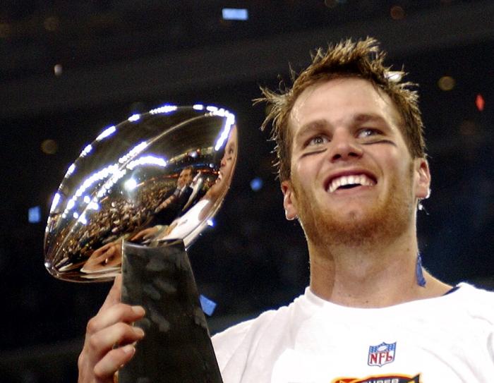 New England Patriots quarterback Tom Brady holds the Vince Lombardi Trophy after the Patriots beat the Carolina Panthers 32-29 in Super Bowl XXXVIII in Houston, Feb. 1, 2004.