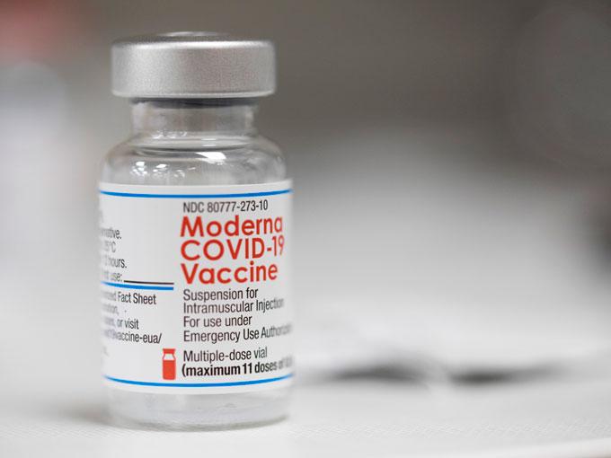 A vial of the Moderna COVID-19 vaccine is displayed on a counter at a pharmacy in Portland, Ore., Monday, Dec. 27, 2021