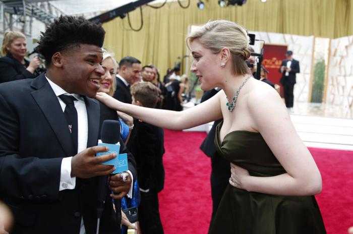 Greta Gerwig, right, talks to Jerry Harris on the red carpet at the Oscars at the Dolby Theatre in Los Angeles, Feb. 9, 2020. 